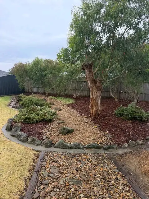 Restored garden with mulch and stone edging (after)