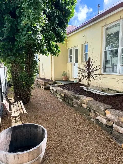 Gravel side path beside a stone-edged garden bed
