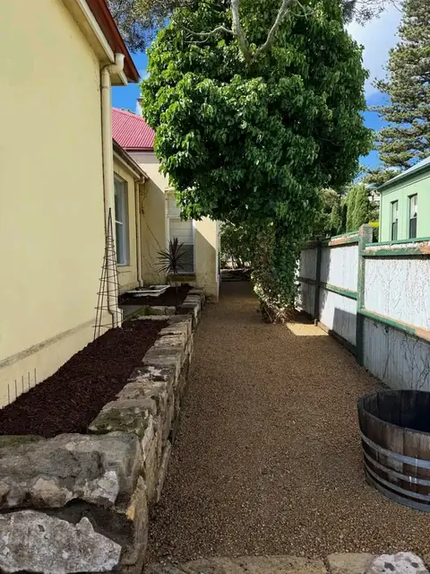 Gravel side path beside a stone-edged garden bed (3 of 3)