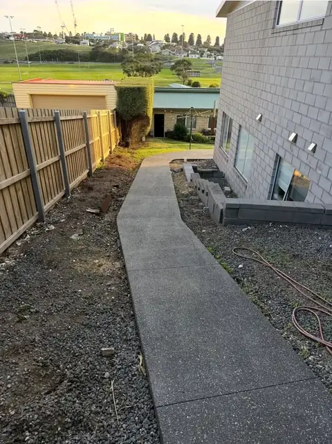 Concrete path with mulched garden beds (before)