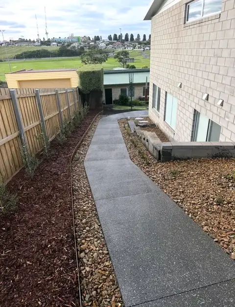 Concrete path with mulched garden beds (after)